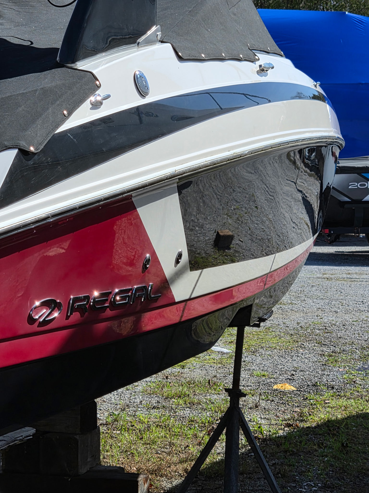 Regal boat stern after gelcoat restoration with restored gloss and sharp reflections
